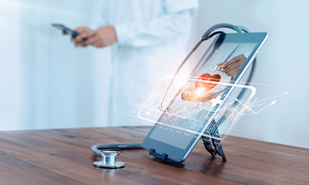 A healthcare professional standing behind an tablet with a stethoscope, heart and someones medical data
