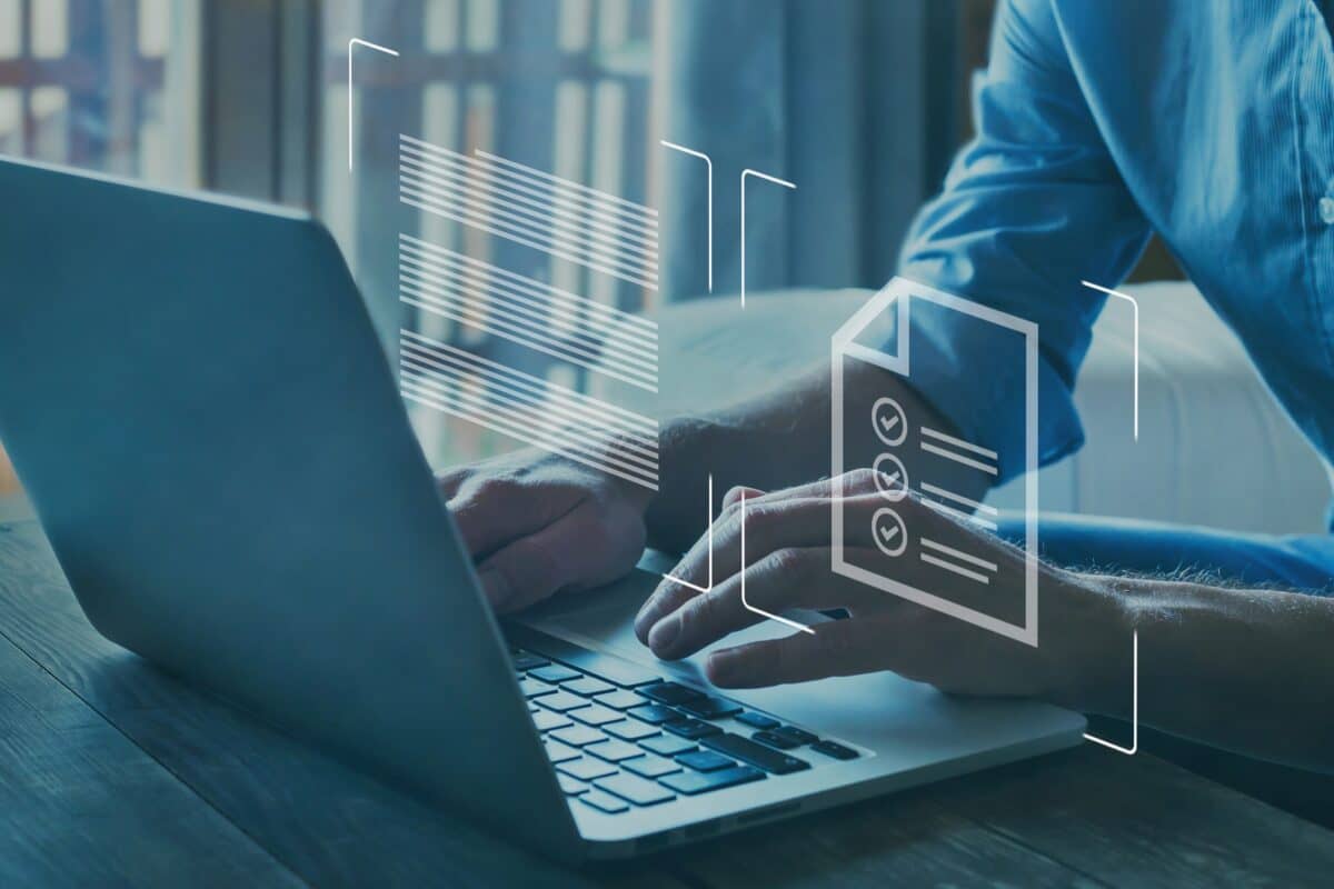 Man on a computer with icons of text and a document