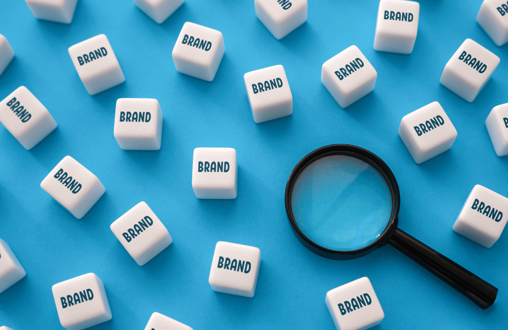 A magnifying glass and multiple blocks with the word brand written on them