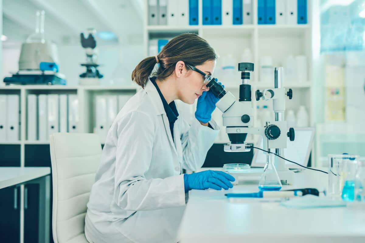 Scientist using a microscope in a laboratory