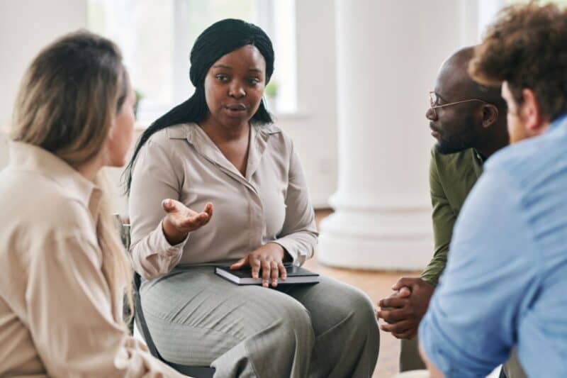 A woman talking to other people in a advocacy group