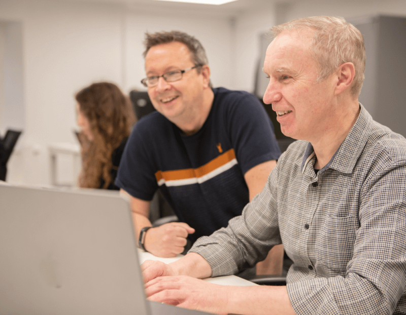 Mark Jeffery and Frank Taylor, Senior Creatives at IGNIFI, looking at a computer screen