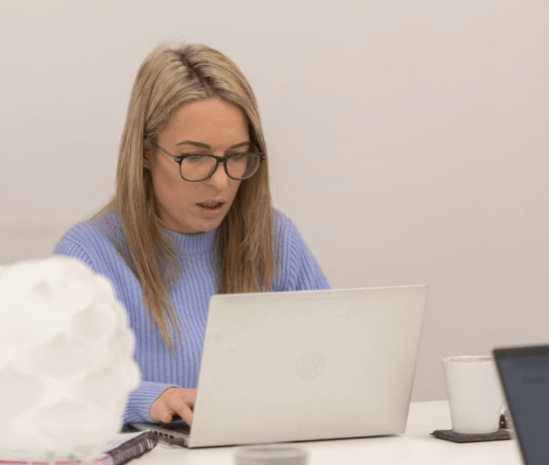 Laura Smith working on a laptop